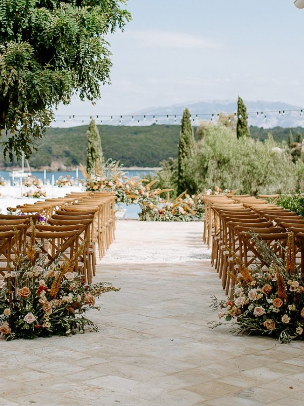 Ceremony chairs and flowers by the sea