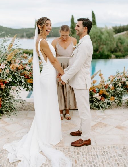 Meghan and Christos with huge smiles while Olivia reads