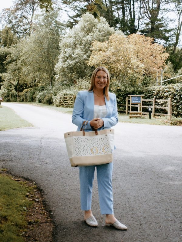 Olivia smiling in beautiful blue suit