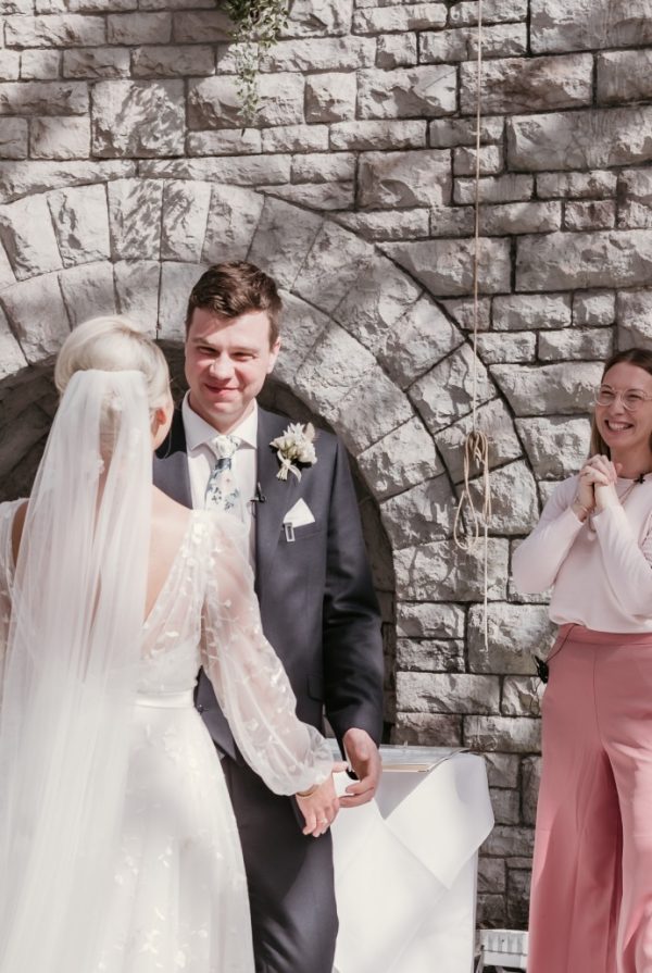 Olivia smiling with newlyweds Claudia & Ashley